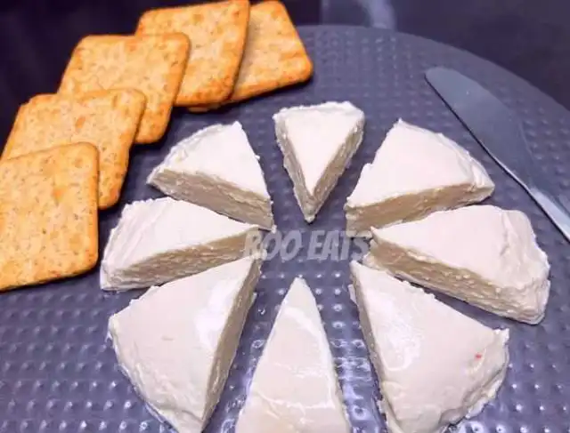 Serving Homemade Cheese On Crackers